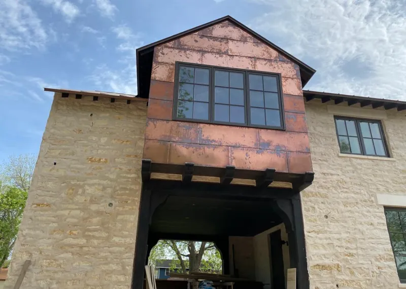 Copper metal panel facade on a stone building for Roof Repair in Morgan Hill